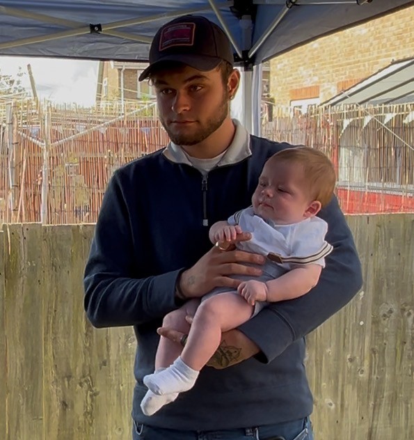 Connor holding baby Oscar.