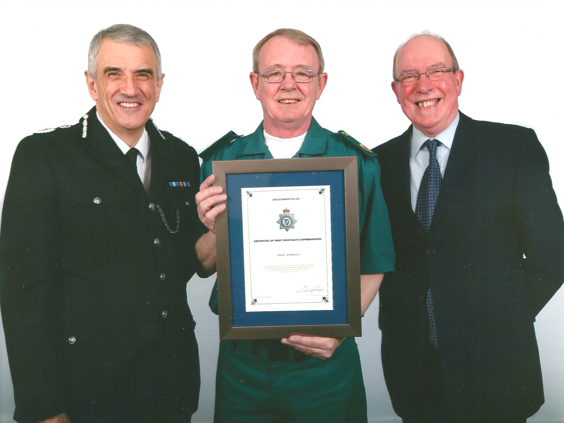 Nick smiles as he holds up his Chief Executive Commendation.