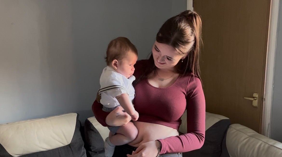 Elli beaming with pride as she holds baby Oscar.
