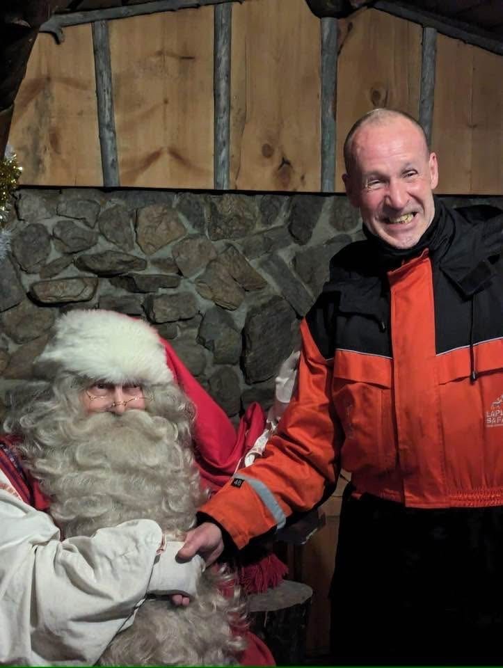 Tim pictured with Santa Clause, showing his beaming smile that the family says Tim will be remembered for most