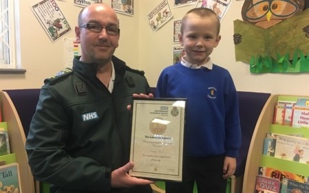 George posed with certificate and first responder
