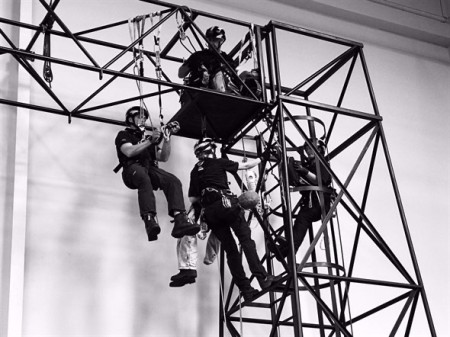 SWAH training, black and white image of responders hanging off a metal frame.jpeg