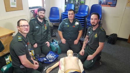 CPD Room, crew posing with the dummy on the floor.jpeg