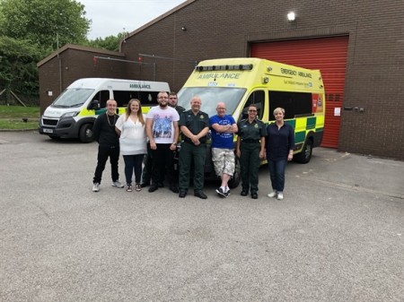 Mark alliot group photo with crew outside an ambulance.jpeg
