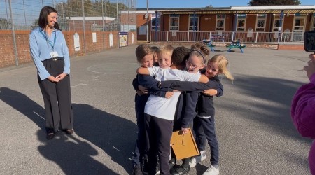 Evalyn is embraced by her class mates after receiving her bravery award