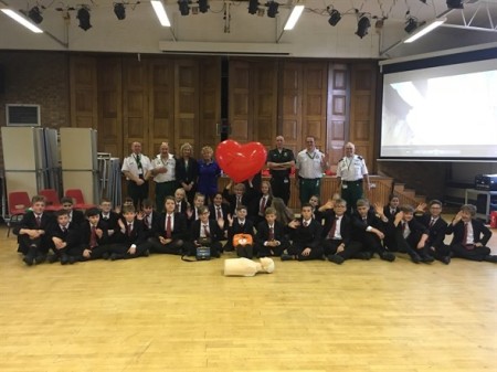 crew and the pupils posing with a giant inflatable heart.jpeg