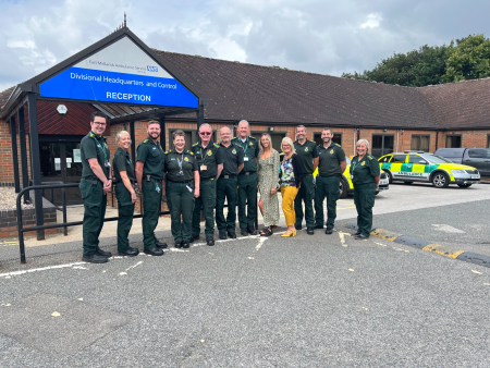 Nick stands with other members of the Lincolnshire divisional team outside of Lincolnshire headquarters. There is an ambulance car to the right of the picture.